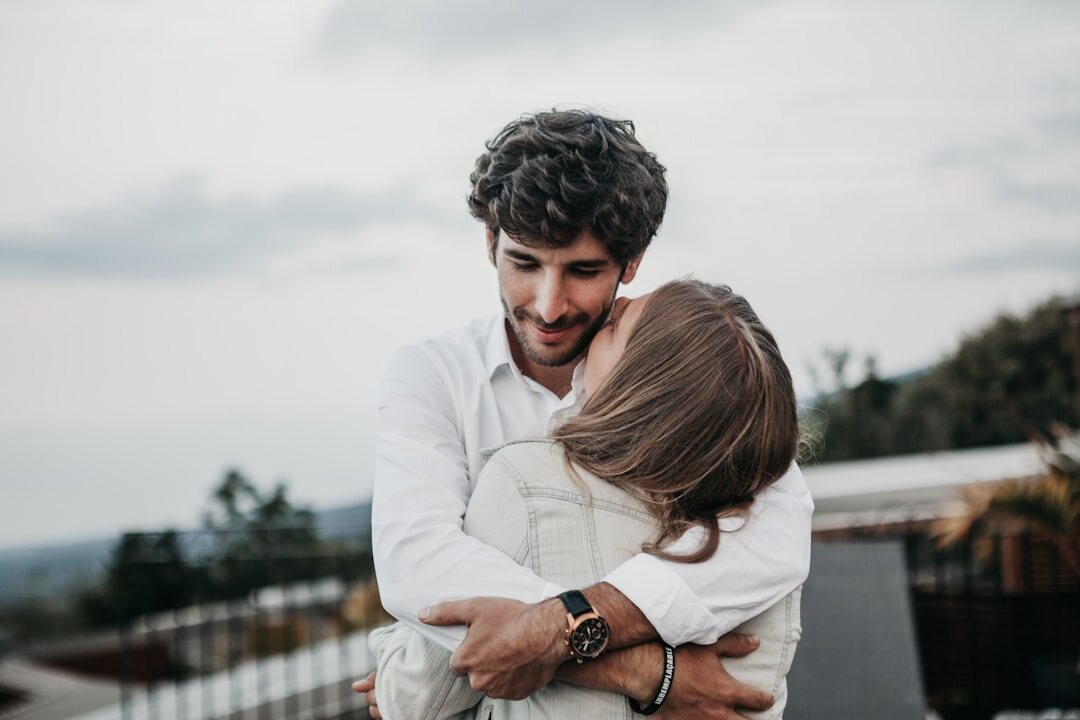 celebrity couple embracing after argument